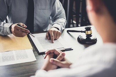 Attorney explaining how to close a workers comp case in California during settlement meeting